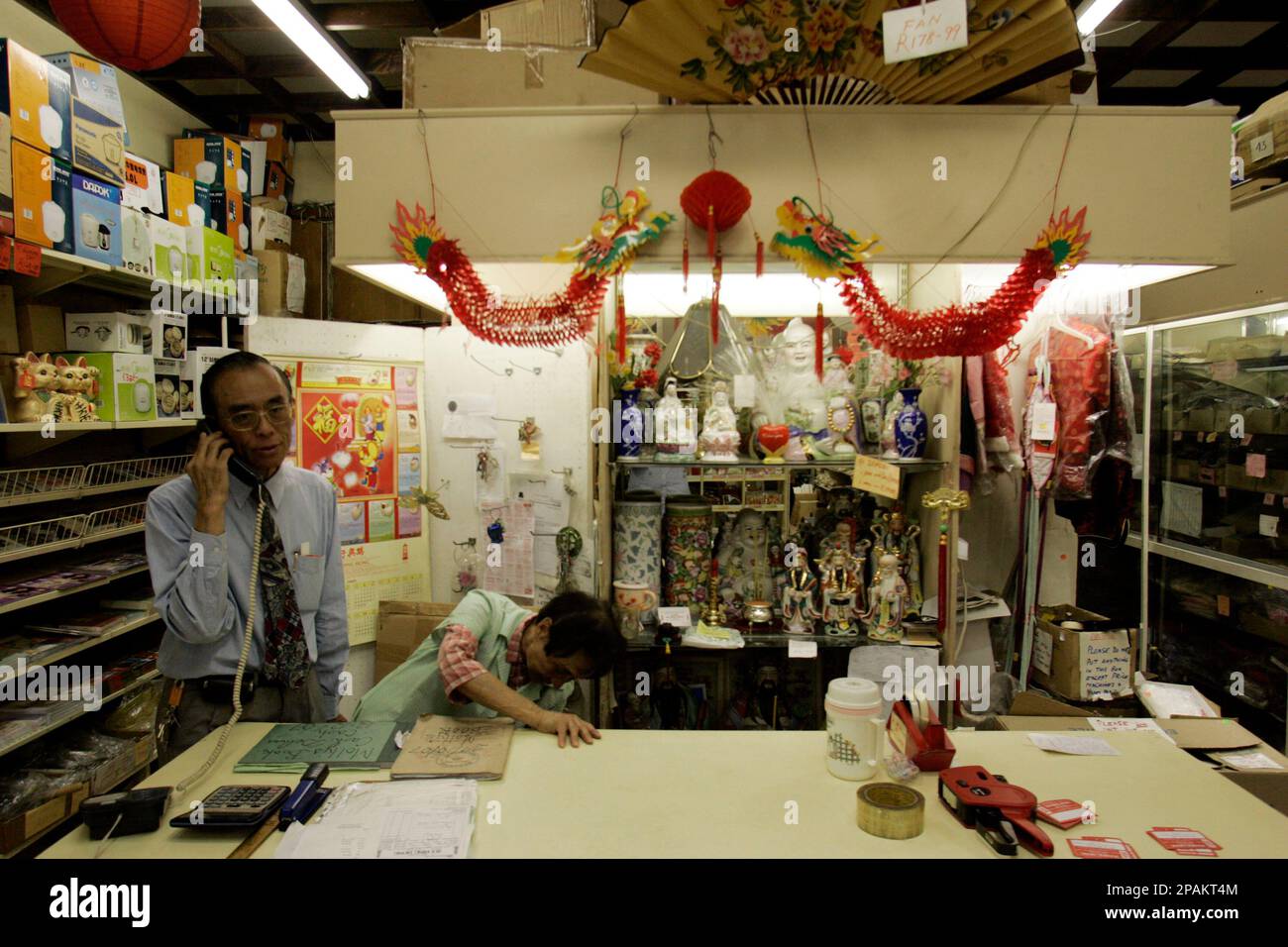 Walter Pon, talks on the phone inside his Sui Hing Hong supermarket in  Johannesburg, South Africa, Monday, Jan. 7, 2008. Standing defiantly among  the fading remnants of Johannesburg's original Chinatown in Commissioner