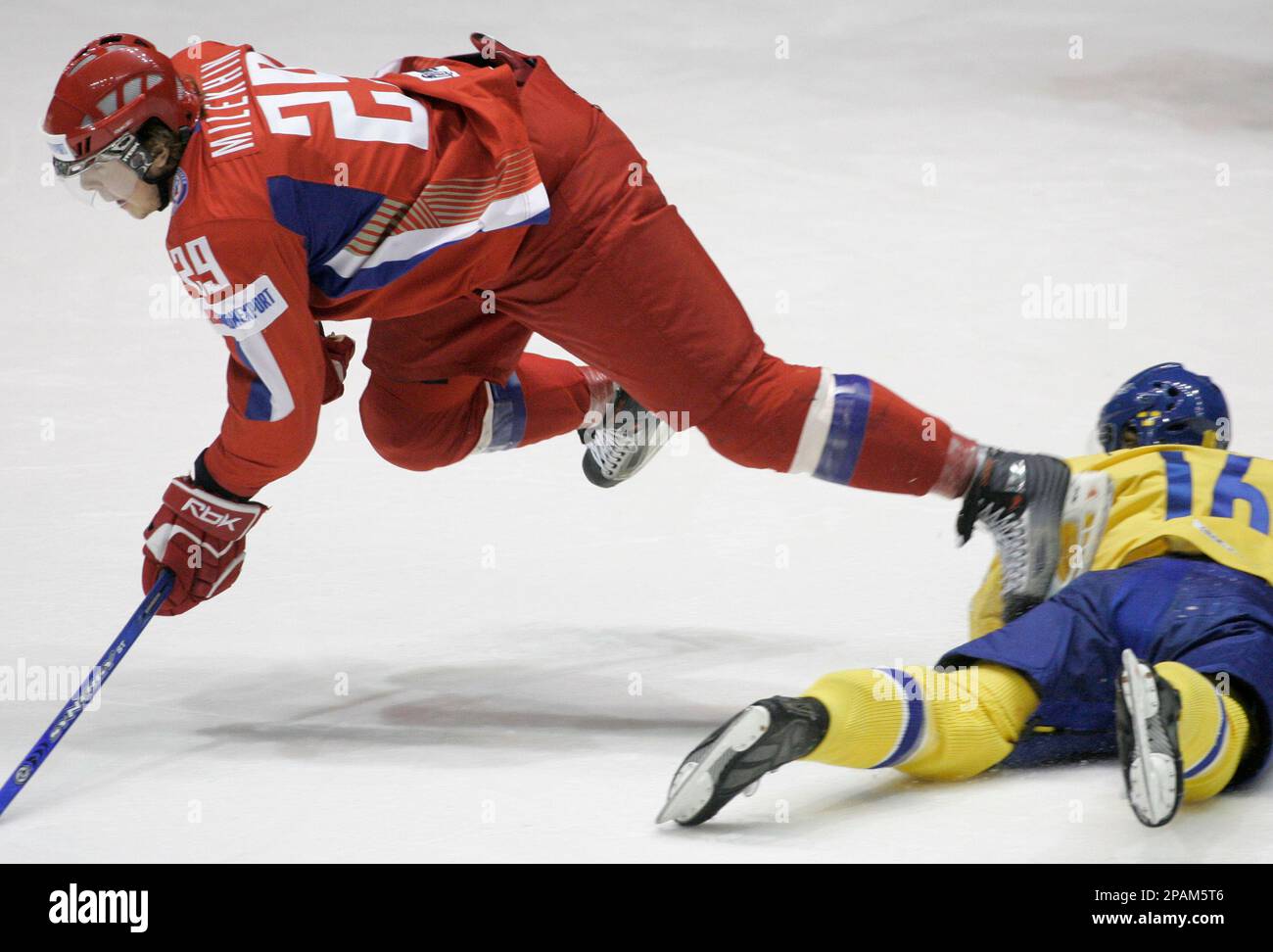 Mikhail Milekhin, left, from Russia trips over Tobias Forsberg, right, from Sweden during their IIHF World U20 Ice Hockey Championships semi-final match in Pardubice, some 130 kilometers (about 85 miles) east of