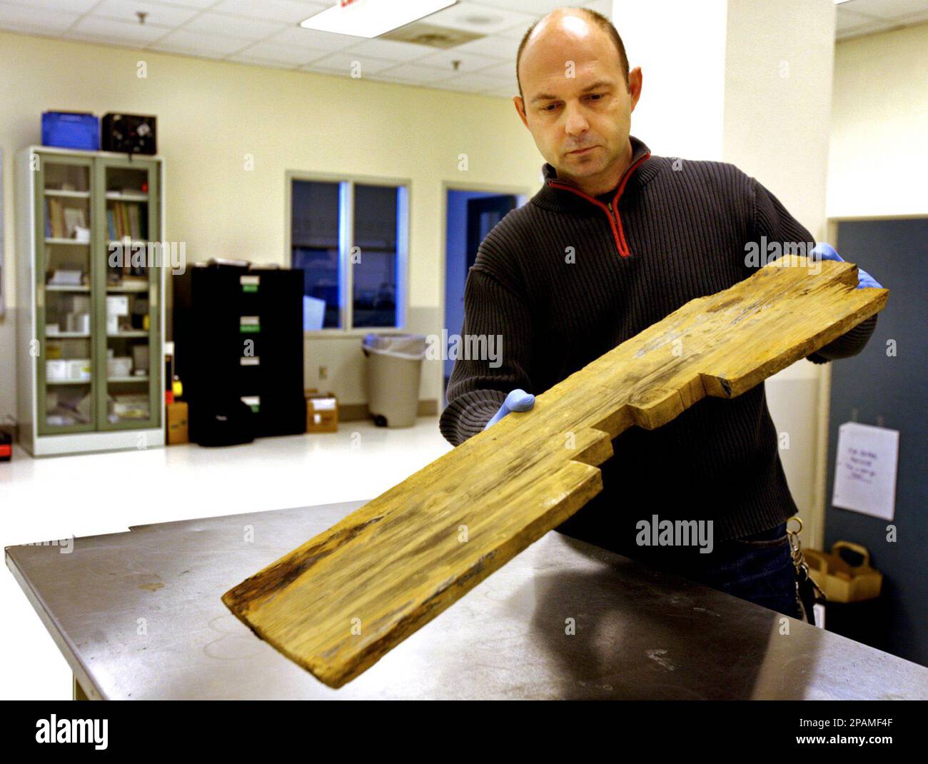 Senior Hunley conservator Paul Mardikian displays the conserved wooden ...