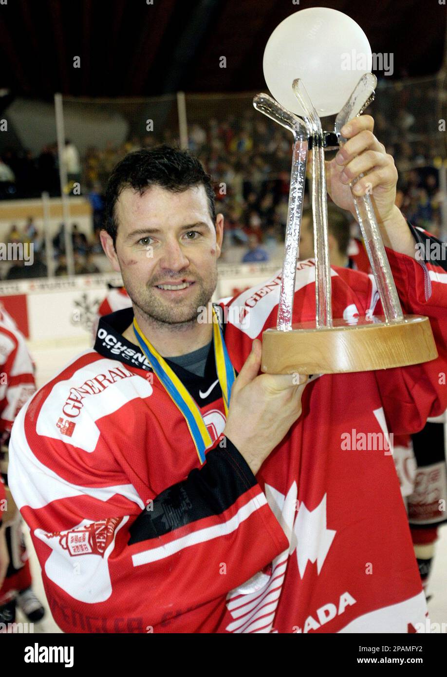 Team Canadas player Serge Aubin presents the winners trophy of the Spengler Cup after Canada won the final game between Team Canada and Salavat Yulaev Ufa, Russia, at the 81th Spengler Cup
