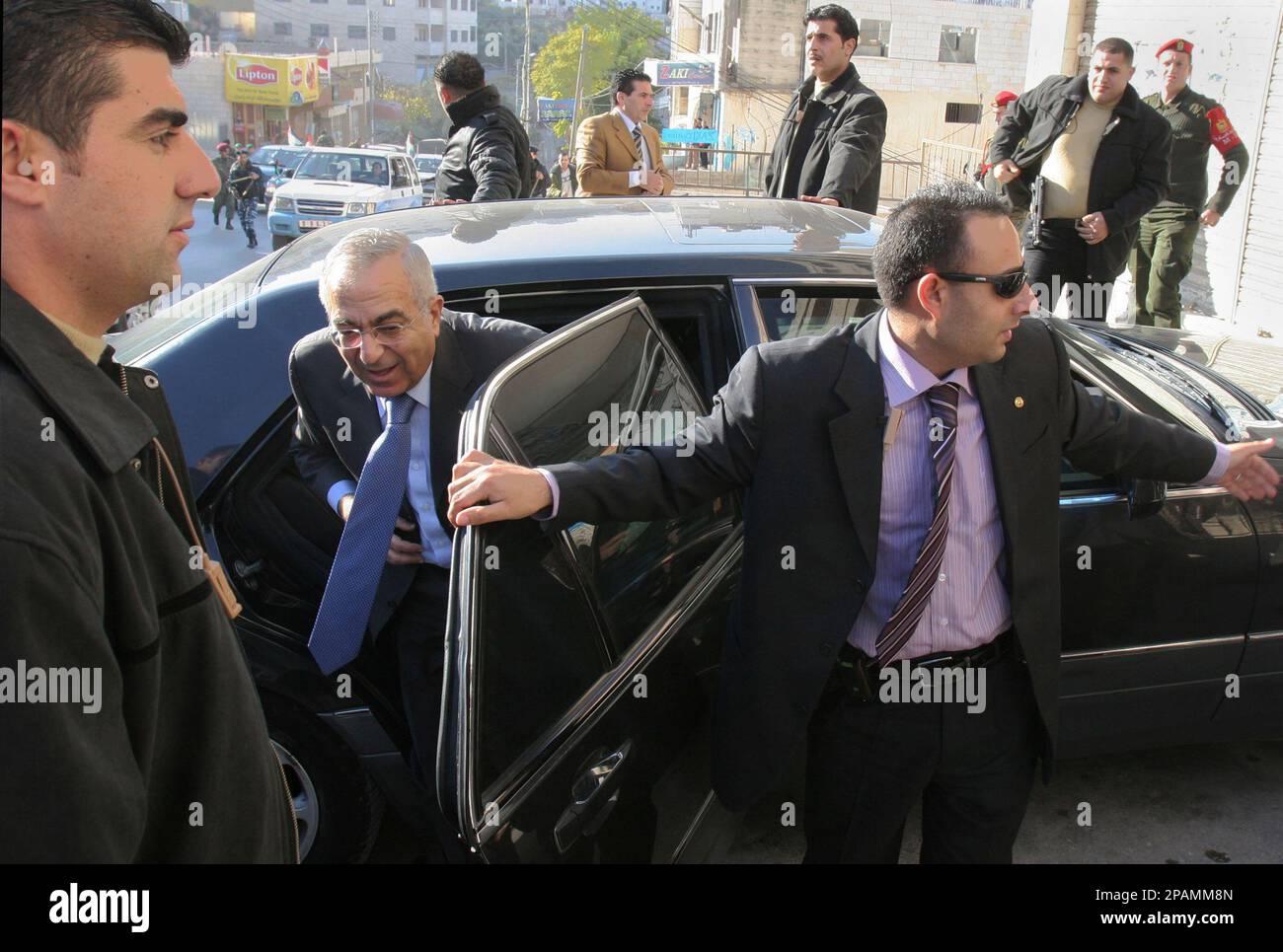 Palestinian Prime Minister Salam Fayyad is surrounded by bodyguards as he  gets out of his car during a visit to the West Bank town of Nablus,  Saturday, Dec. 29, 2007.(AP Photo/Nasser Ishtayeh