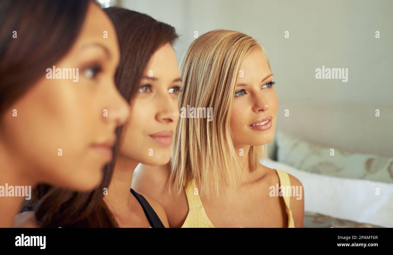 Girls day. three attractive young women sitting together indoors. Stock Photo