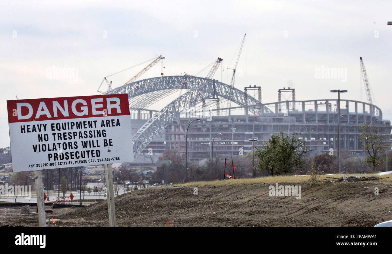 A warning sign stands outside the new Dallas Cowboys stadium, under  construction in Arlington, Texas, Wednesday, Dec. 19, 2007. City leaders are  worried that growing gang violence in other parts of the