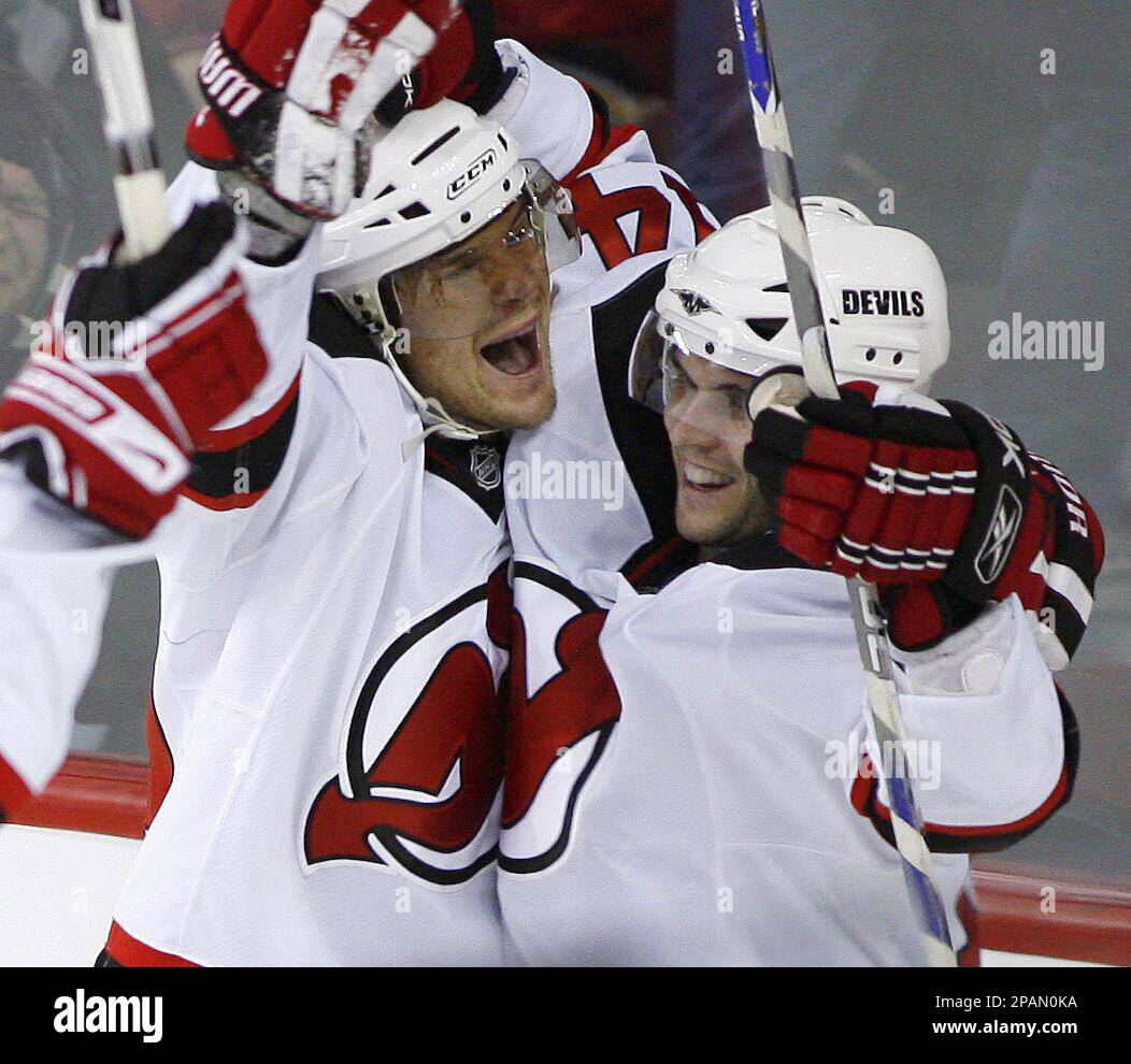 New Jersey Devils' Patrik Elias, left, of the Czech Republic, celebrates  his overtime goal against the Calgary Flames with teammate Brian Gionta  during an NHL hockey game in Calgary, Alberta, on Sunday,