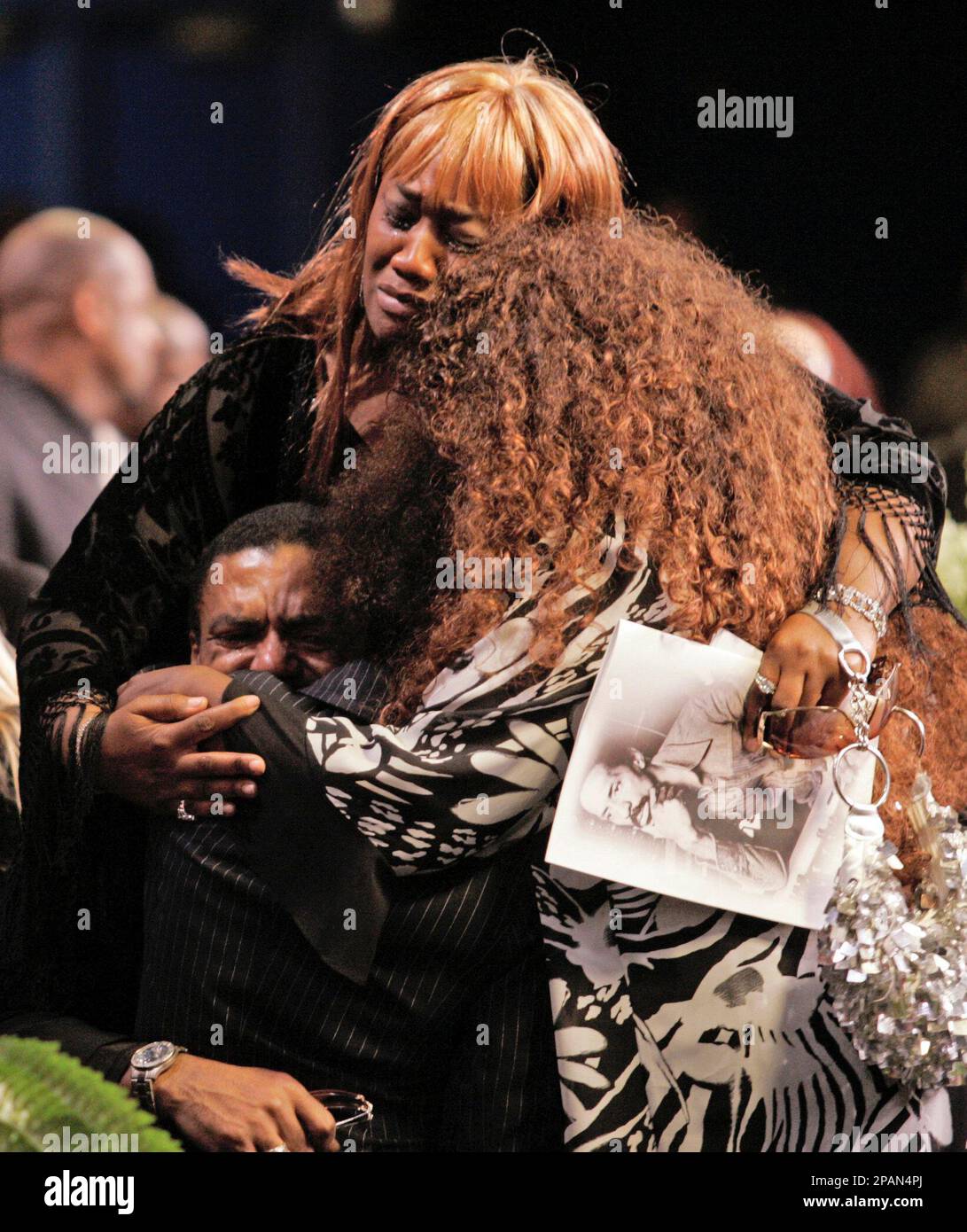OBIT**Ike Turner Jr., center, is embraced by two unidentified women during  a memorial service of his late father Ike Turner at City of Refuge Church  in Gardena, Calif., Friday, Dec. 21, 2007. (, image size:1091x1390