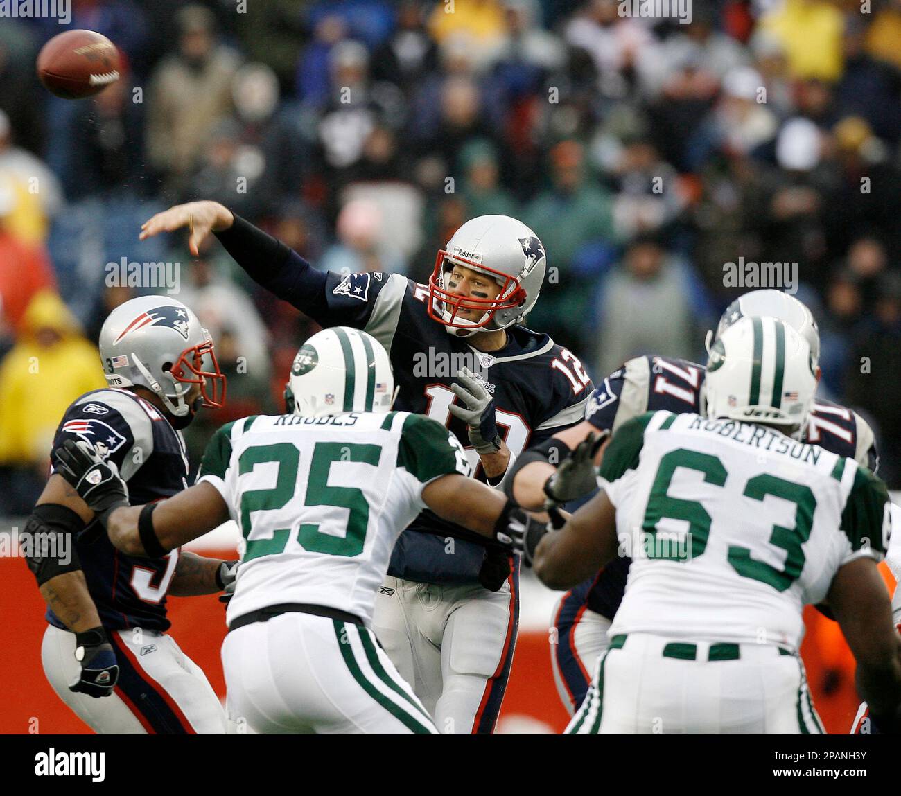New England Patriots quarterback Tom Brady throws over New York Jets' Kerry  Rhodes (25) and Dewayne Robertson (63) during their 20-10 win over the New  York Jets in a football game at
