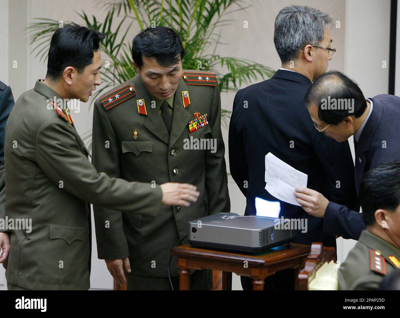 Supporting officers, 1st and 2nd right, of South Korean delegation ...