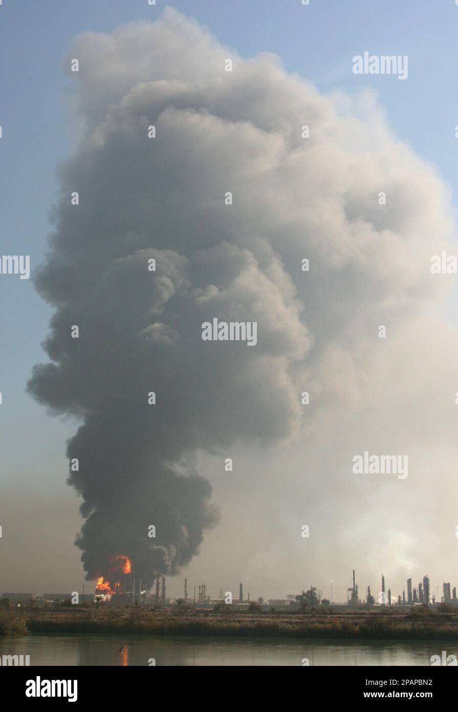 Flames and smoke rises from al Dora oil refinery in South Baghdad, Iraq ...