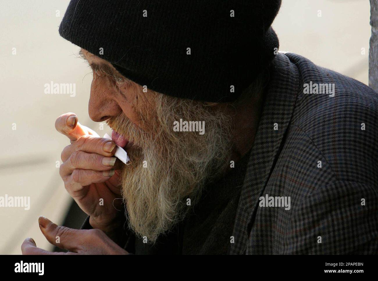 An old man in Amman, Jordan makes a hand-made cigarette on Sunday Dec.9,  2007. Old men, especially in the rural and Bedouin areas, smoke a locally  grown tobacco called 