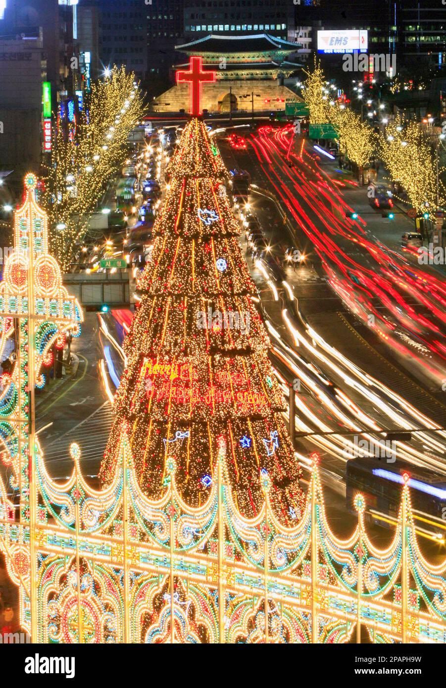 A Christmas tree and decorations are light up in front of Seoul ...