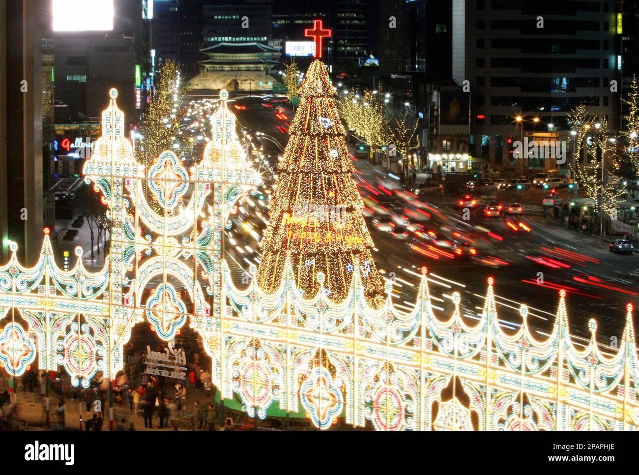 A Christmas tree and decorations are lit up in front of Seoul City ...