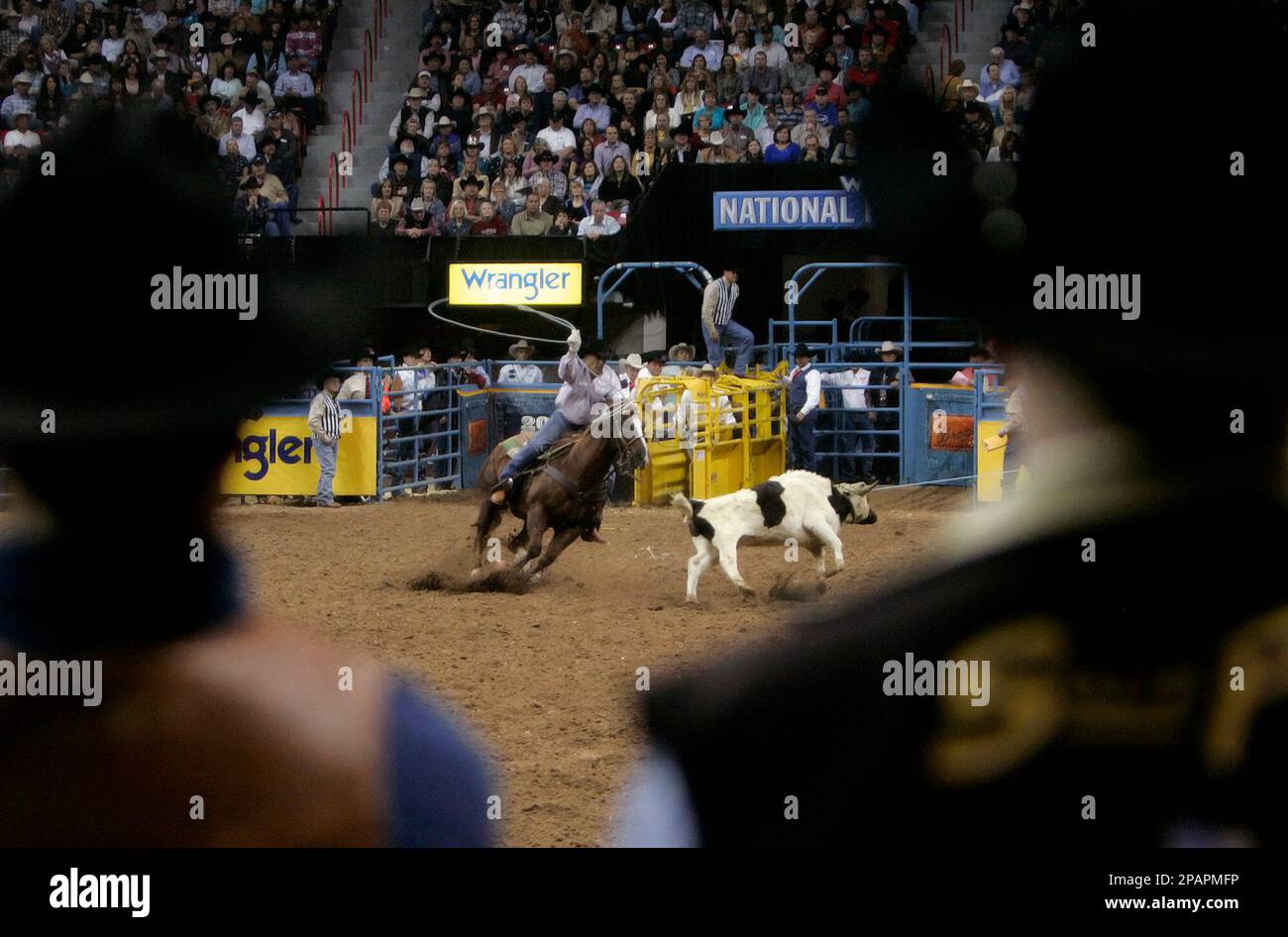Walt Woodard, center, is framed by cowboys as he competes in the first ...