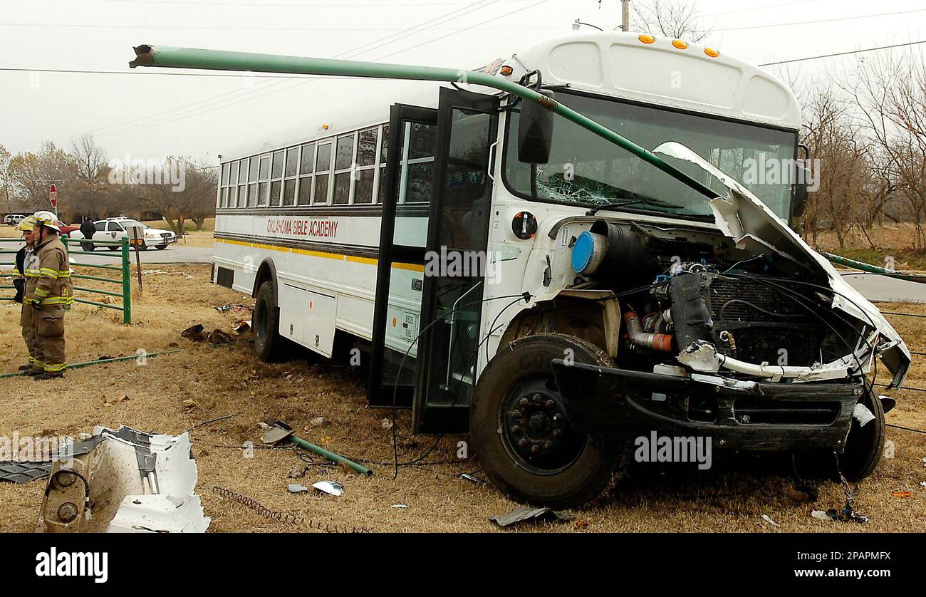 A school bus from Oklahoma Bible Academy rest in a fence row after