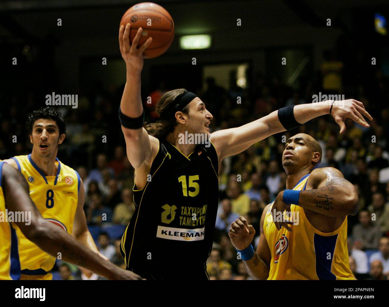 Aris Thessaloniki's Lazaros Agadakos, center, goes to the basket past  Maccabi Tel Aviv's Marcus Fizer of the United States, right, and Maccabi  Tel Aviv's Lior Eliyahu , left,during their Euroleauge group B