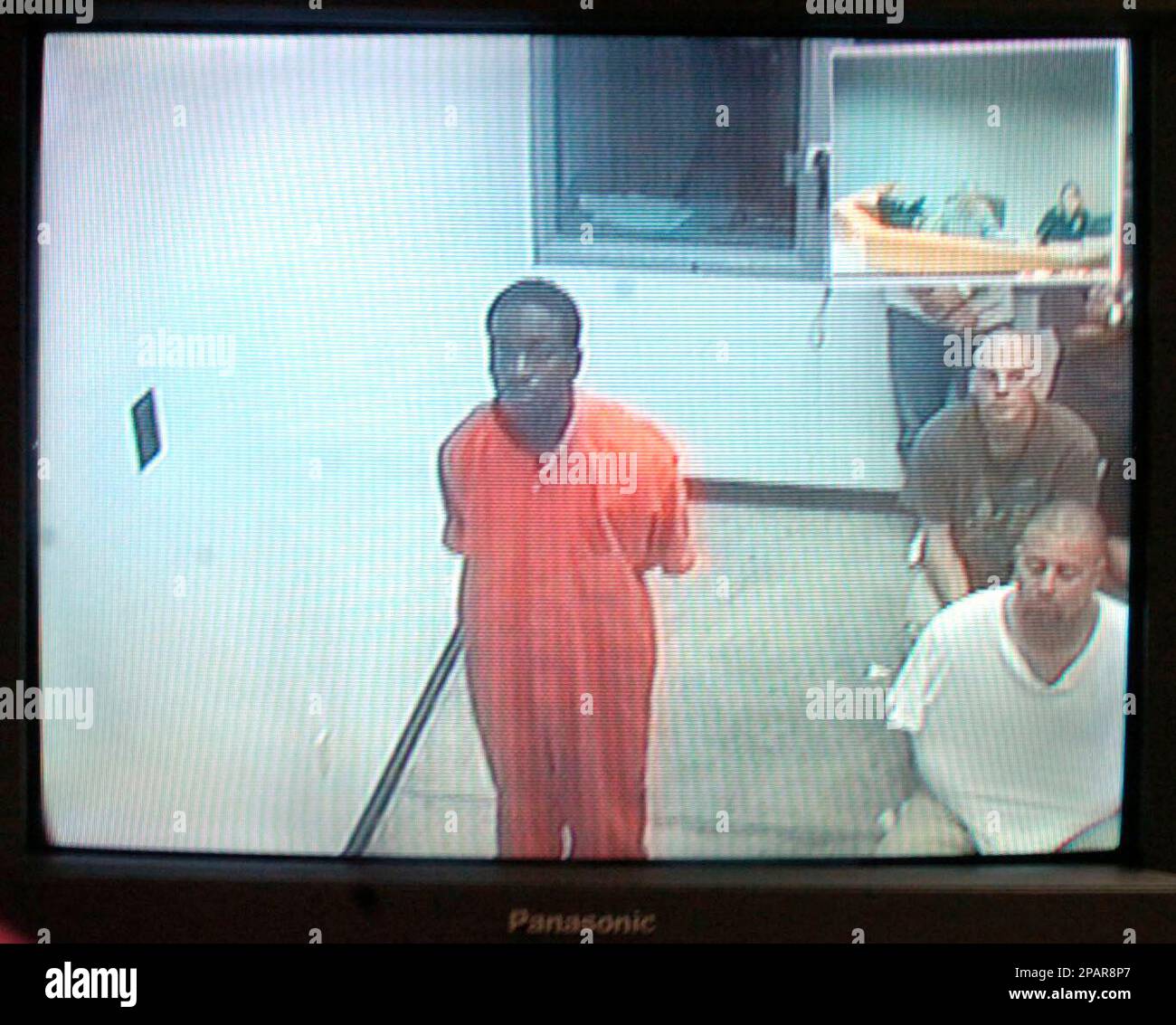Charles Wardlow, 18, center, appears via closed circuit television at