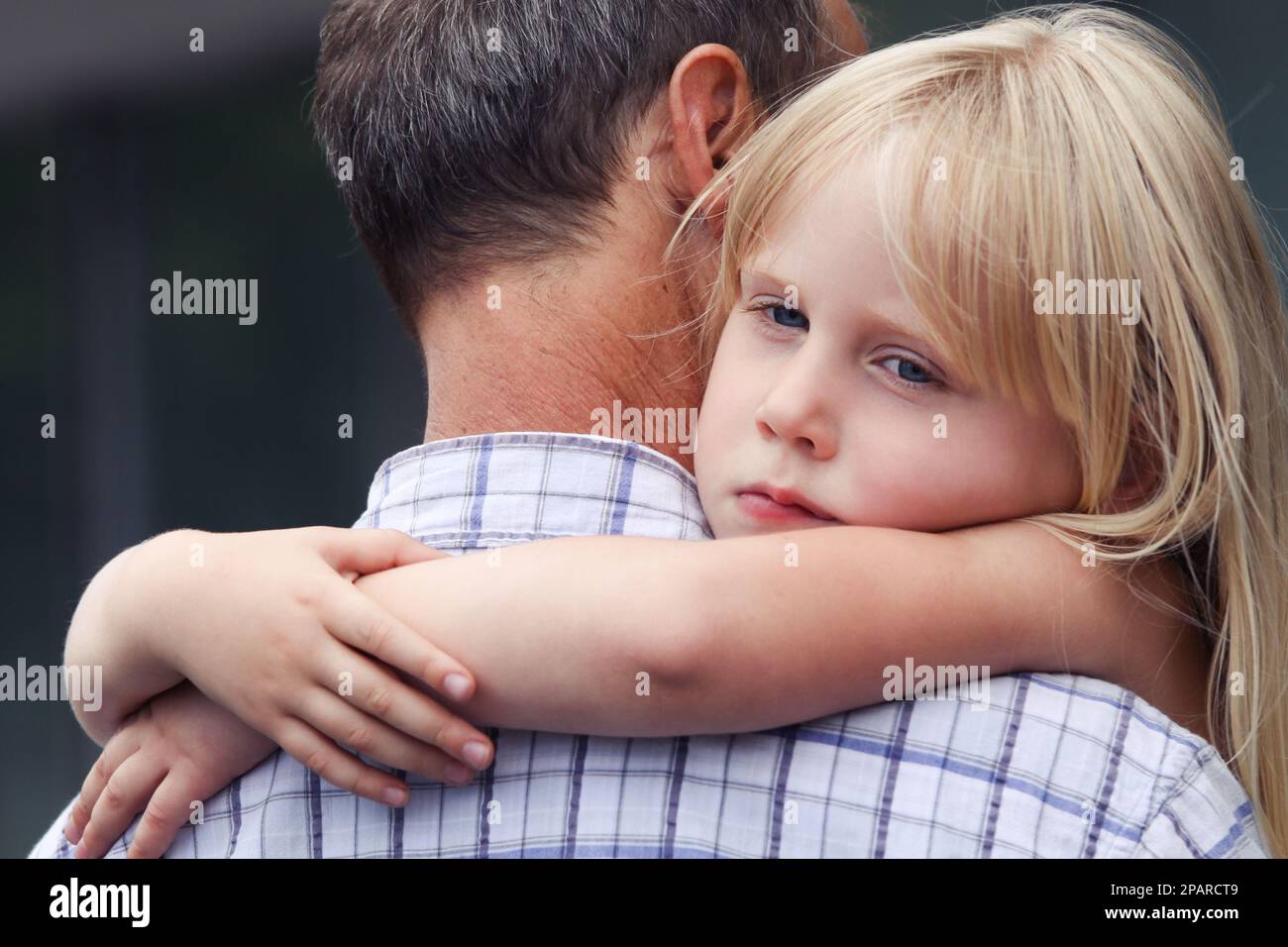 Father full of love and care for her child. Tired kid girl. Back view Stock Photo