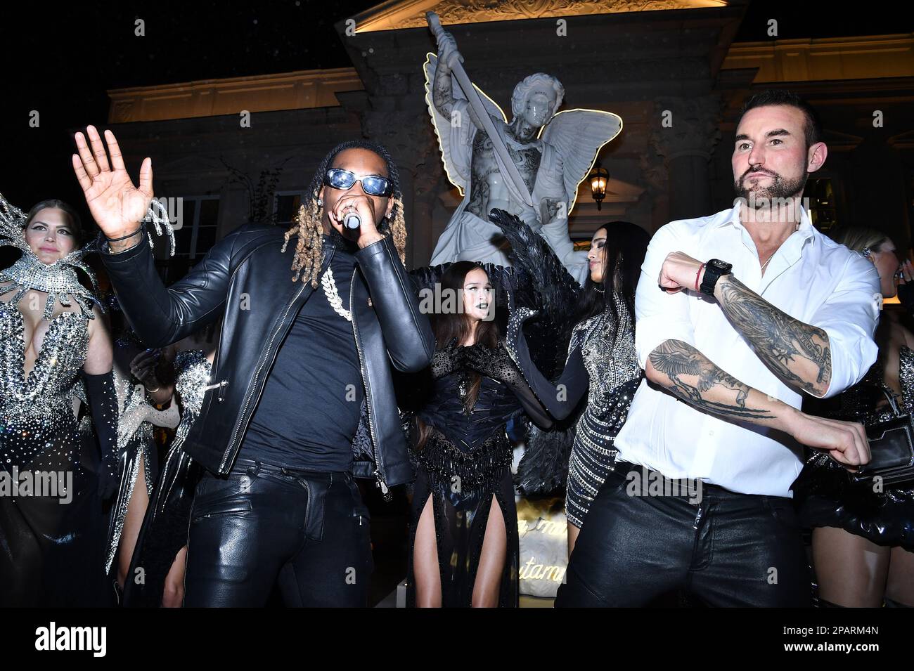 Los Angeles, USA. 11th Mar, 2023. Designer Philipp Plein (white shirt)  dances next to rapper Offset as he performs at the Philipp Plain Atelier  Los Angeles fashion show collection at the Chateau