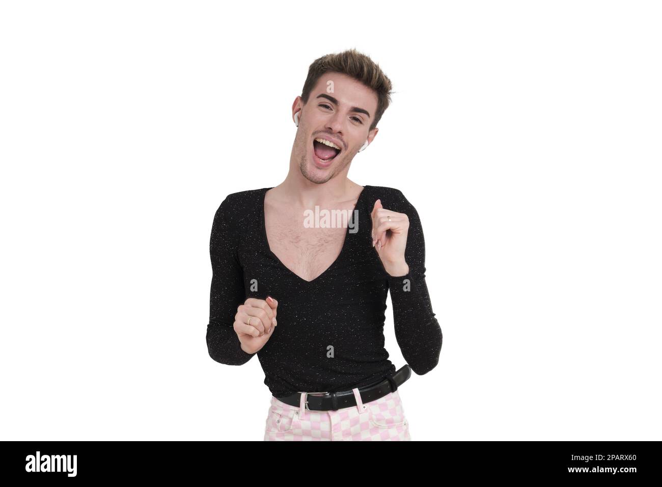 Young caucasian man dancing with earphones, isolated. Stock Photo
