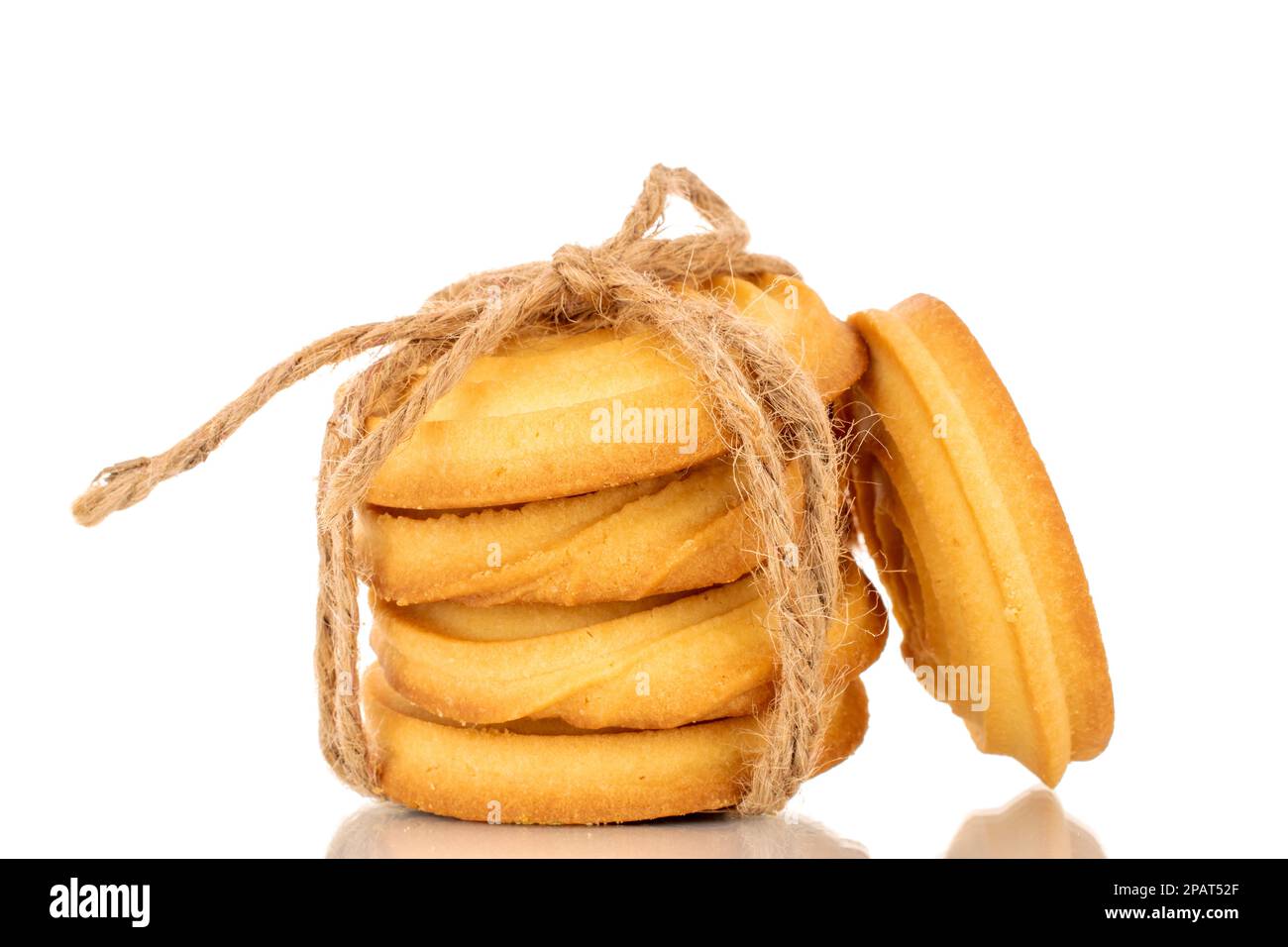 Several sweet cookies tied with jute rope, macro, isolated on white background. Stock Photo