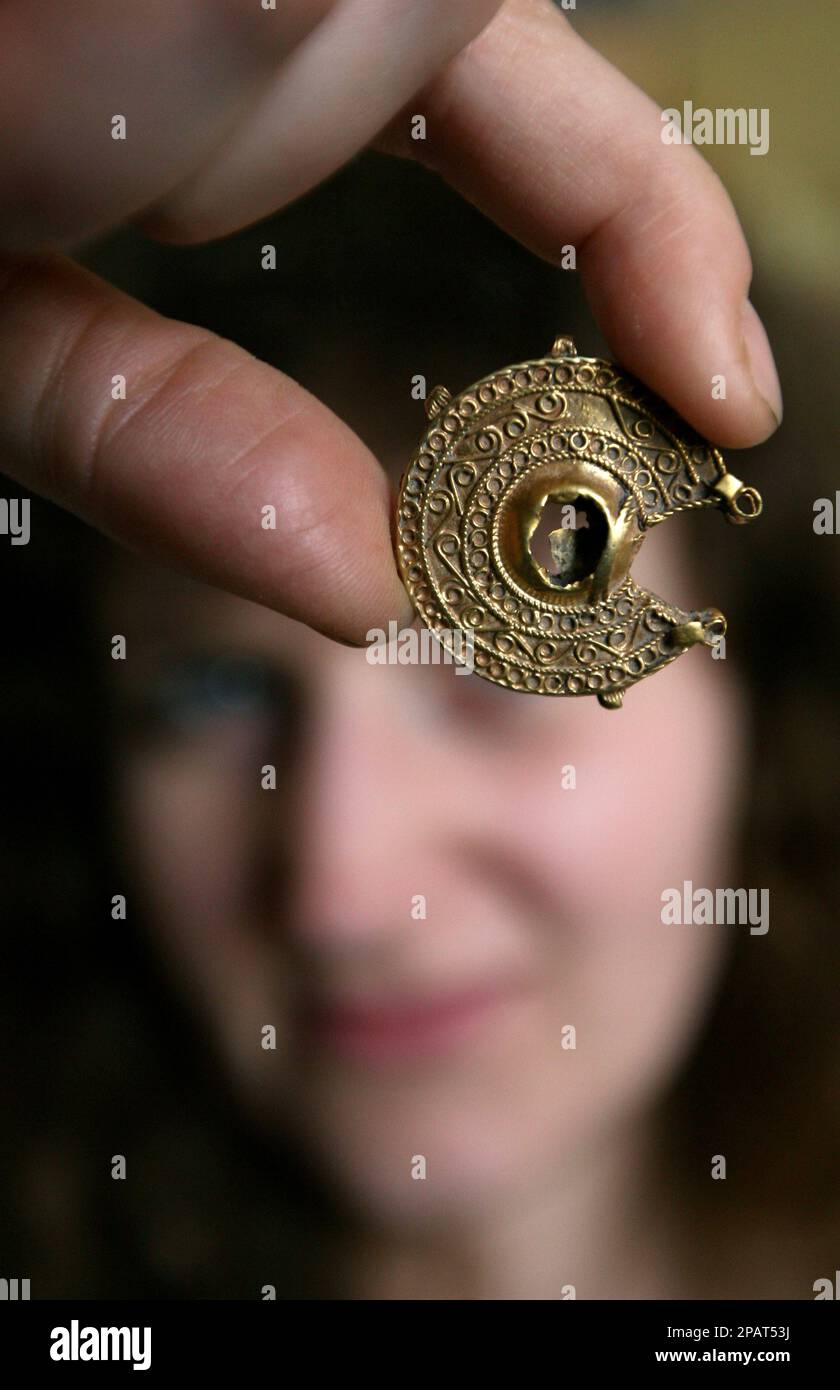 An archaeologist shows a part of a 700-year-old gold treasure found near  the village of Shkorpilovci, east of the Bulgarian capital Sofia, Friday,  Nov. 23, 2007. Part of the treasure like a