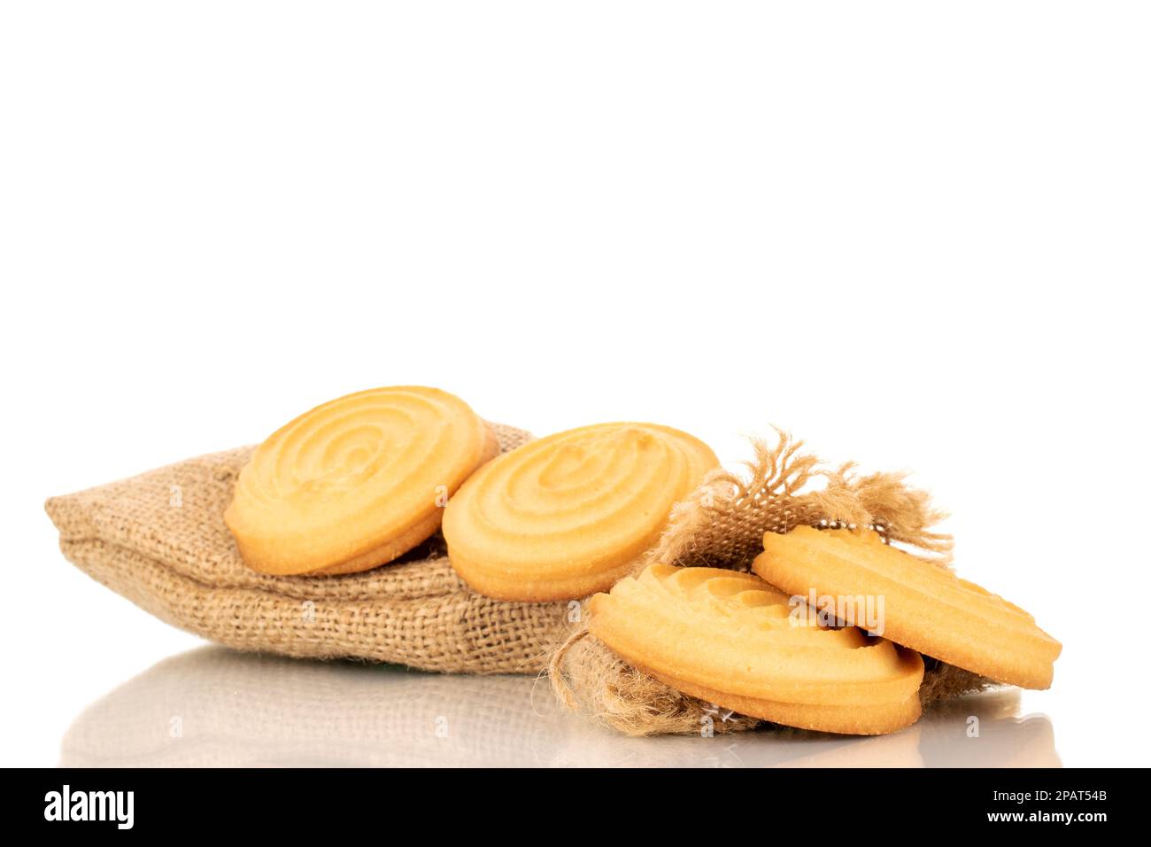 Several sweet cookies with jute bag, macro, isolated on white background. Stock Photo