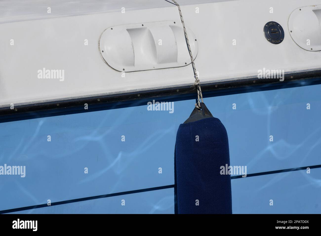 Traditional Greek fishing boat starboard with a heavy balloon fender