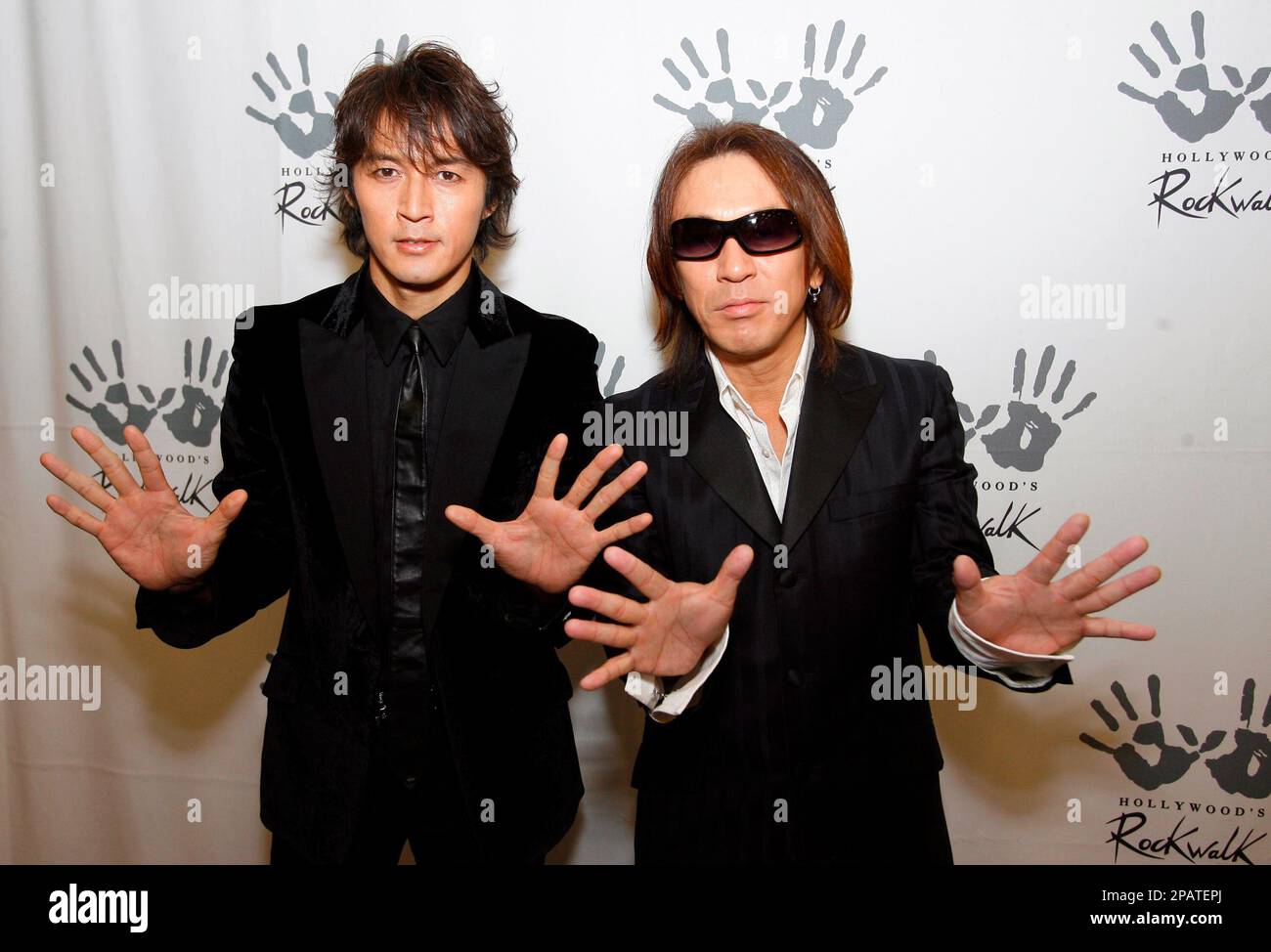 Japanese rock band B'z duo, guitarist Tak Matsumoto, right, and ...