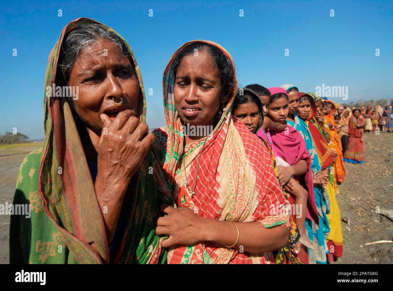 Cyclone-affected villagers queue for cooked meals in Patargata, 200 ...