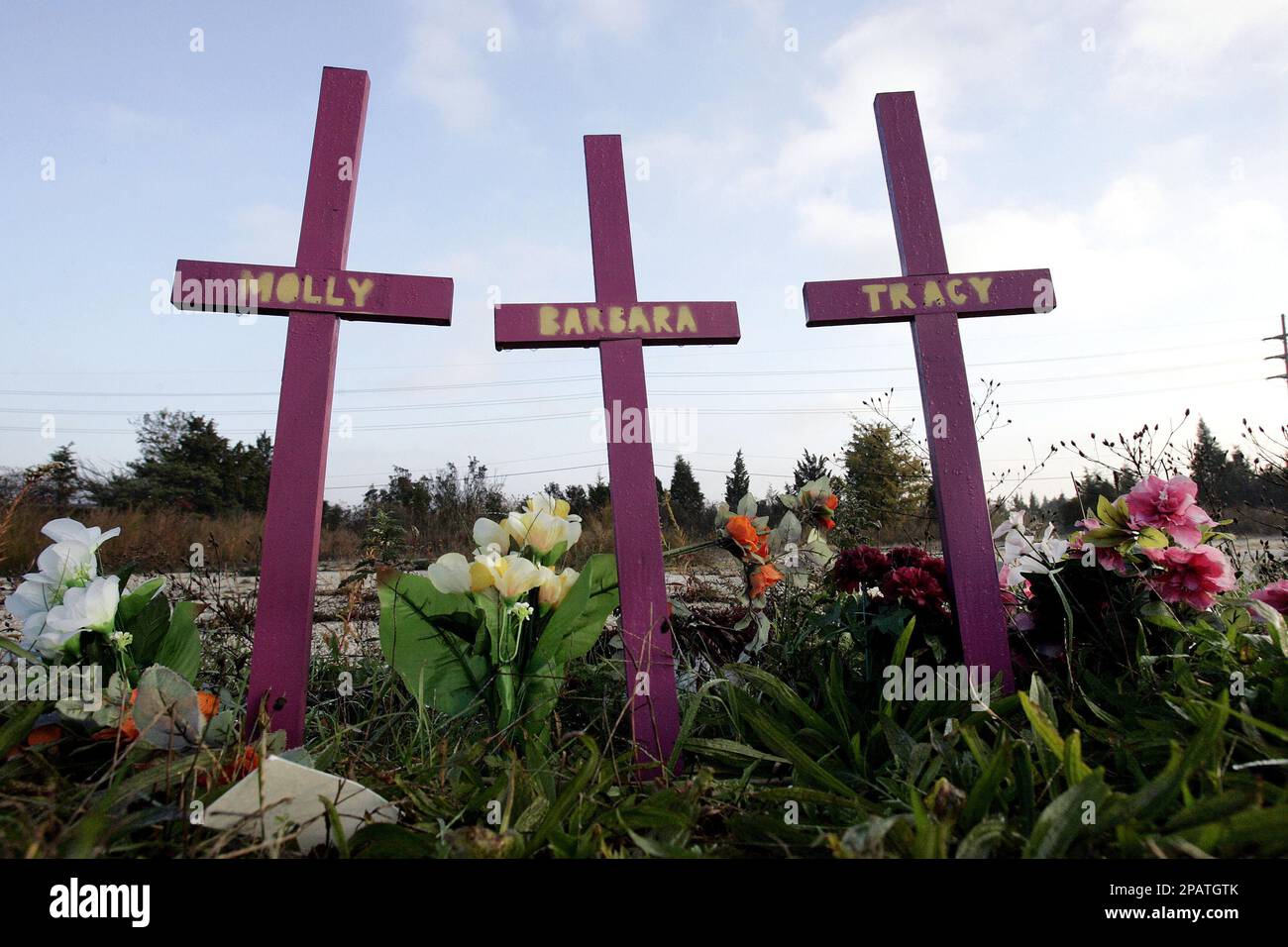 Three crosses stand, surrounded by flowers, in Egg Harbor Township, N.J.,  Wednesday, Nov.14, 2007, not far from the area where nearly a year ago,  four Atlantic City-area prostitutes were found slain. On