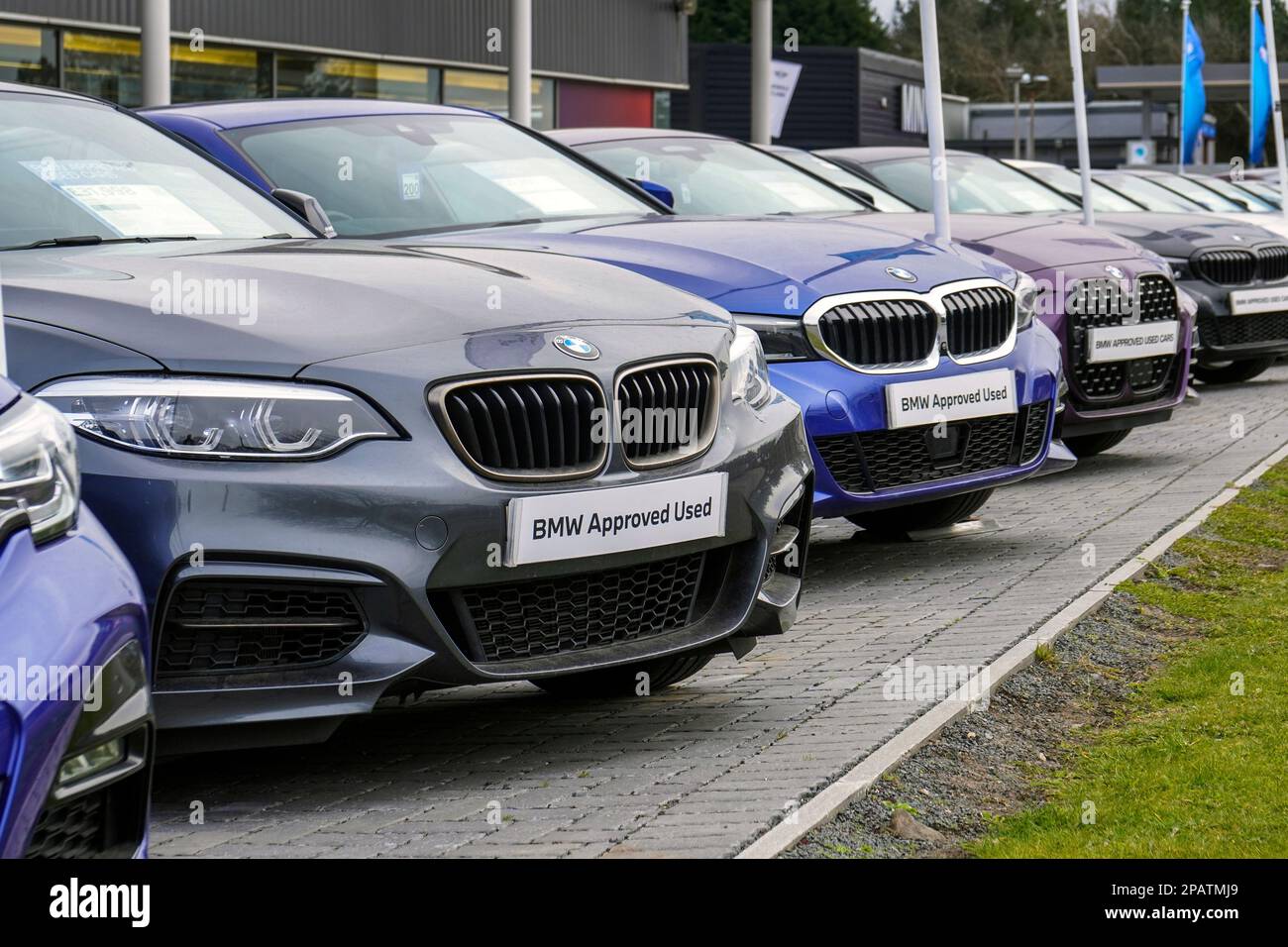 Selection of secondhand BMW cars for sale in a garage forecourt, UK Stock Photo
