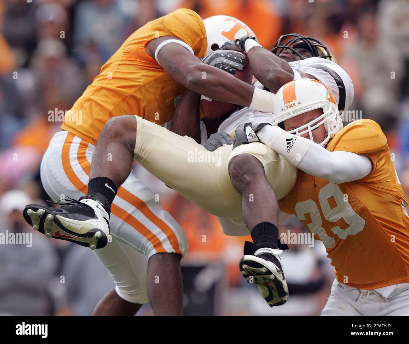 Vanderbilt's Earl Bennett, center, is hit by Tennessee's Jerod Mayo, left,  and Ryan Karl (39) as he catches the ball during a college football game  Saturday, Nov. 17, 2007 in Knoxville, Tenn.(AP