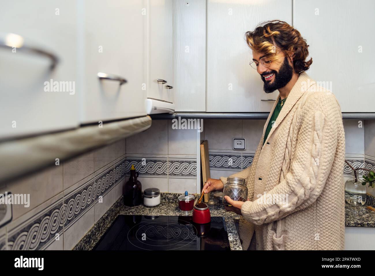 young man preparing coffee in the kitchen at home Stock Photo