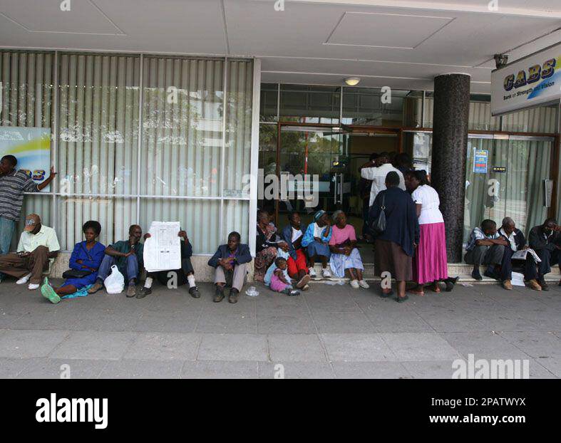 People wait in a bank queue in Harare, Friday, Nov, 16, 2007. Zimbabwean  banks are facing chronic shortages of cash with long queues now forming at  automatic teller machines and banking halls.