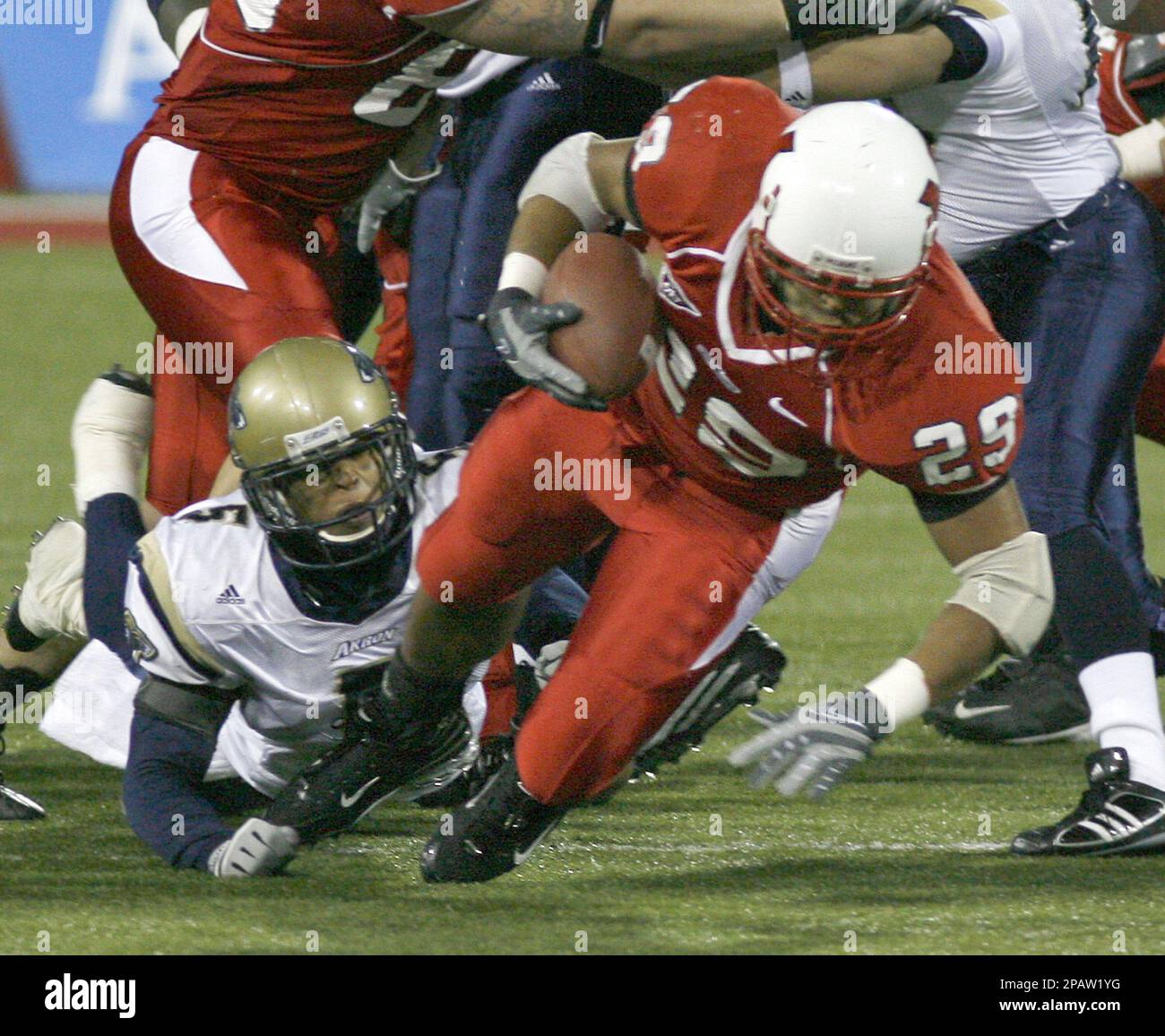 Miami Ohio running back Austin Sykes (29) is brought down by Akron  defensive back Davanzo Tate (5) in the first quarter during their football  game Wednesday, Nov. 14, 2007, in Oxford, Ohio. (