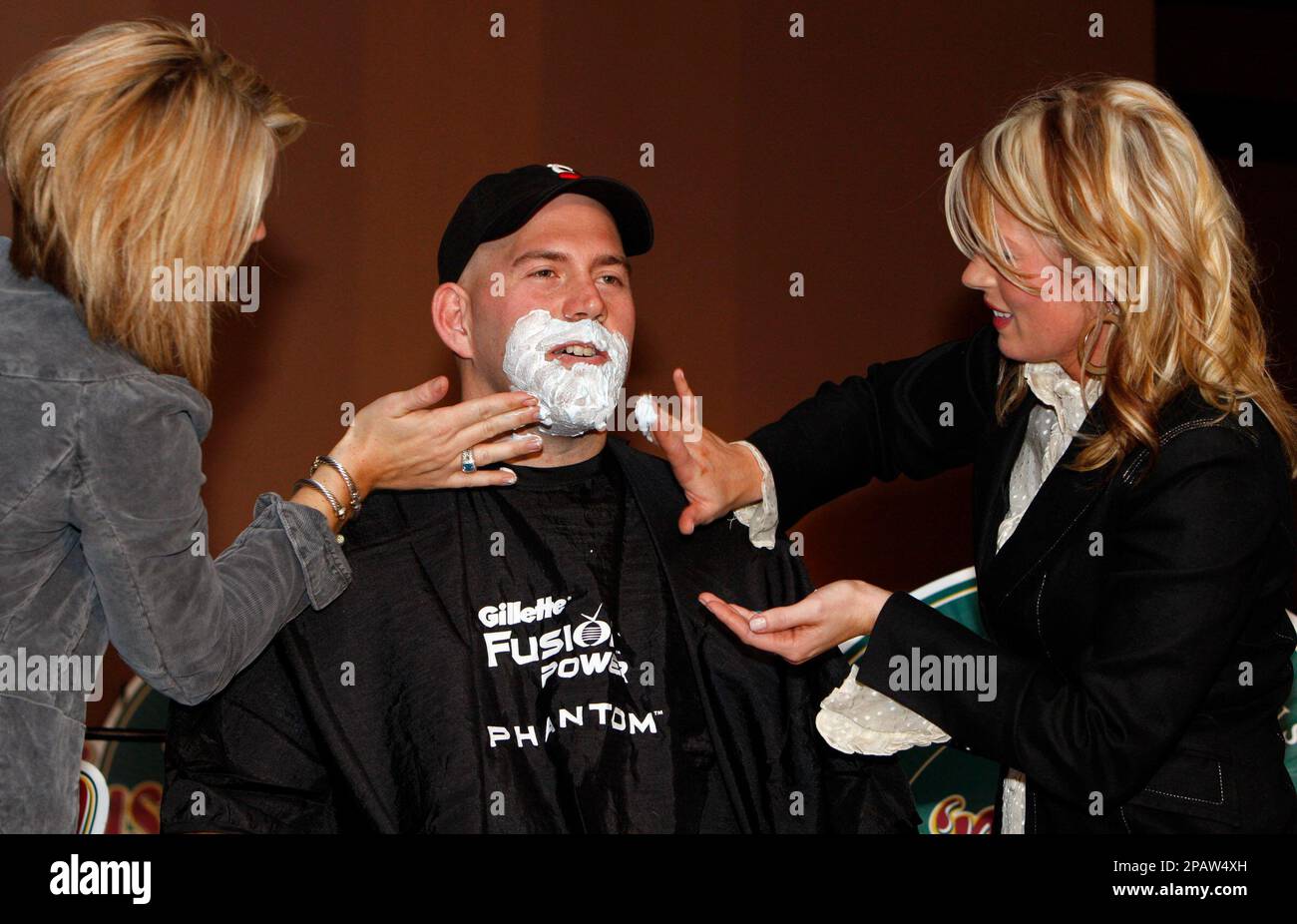 Stylist Meagan Boyle, left and Michelle Fonzi apply shaving cream to Boston  Red Sox first baseman Kevin Youkilis before shaving off his goatee as part  of a charity event Tuesday, Nov. 13
