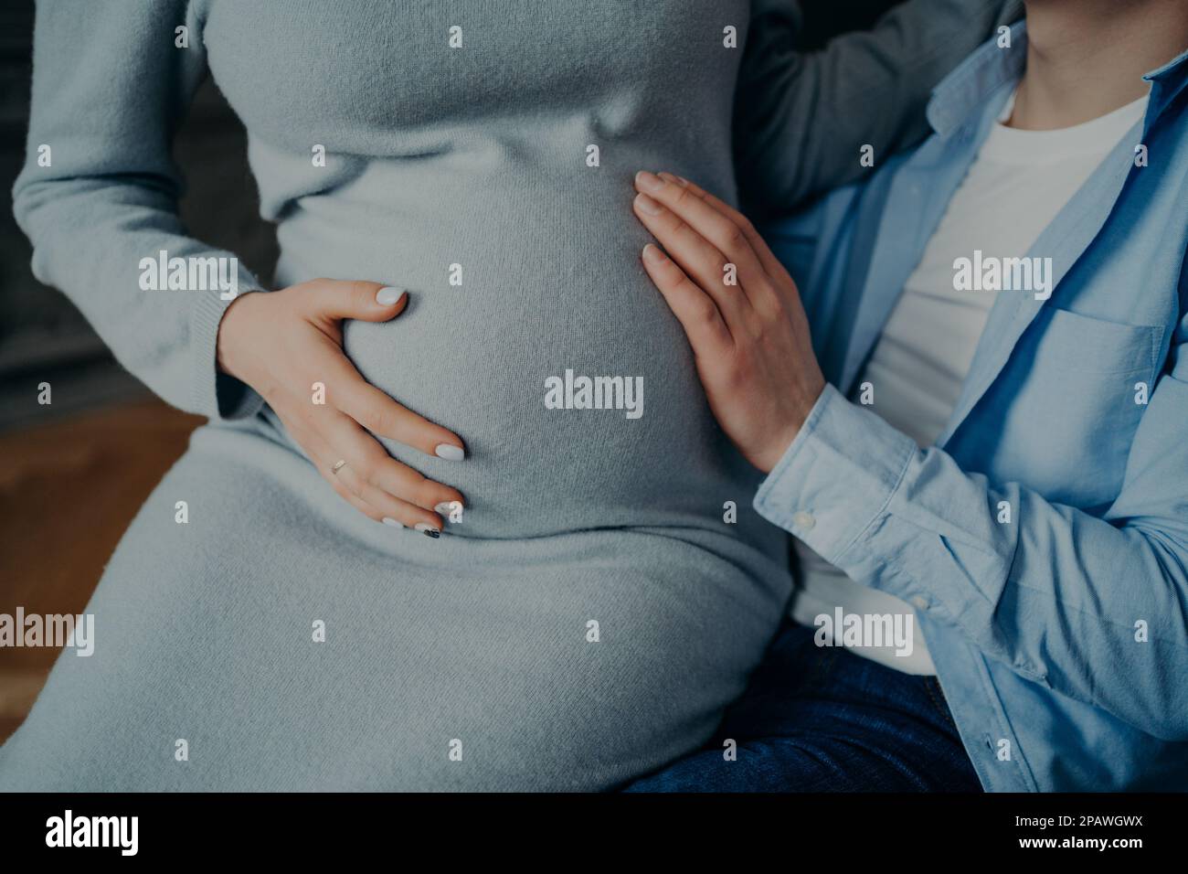 Pregnancy and family concept. Cropped shot of pregnant woman touches