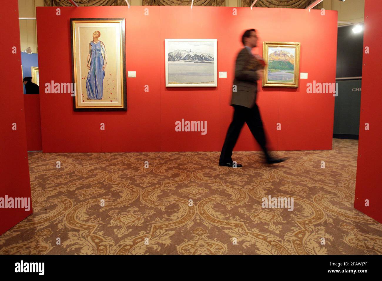 A Christie's employee displays the painting "Thunersee mit Stockhornkette  im Winter" painted in 1912/13 by Swiss artist Ferdinand Hodler, during a  viewing in Geneva, Switzerland, Friday, Nov. 9, 2007. The painting will