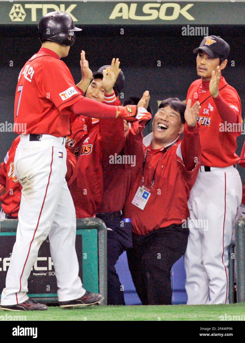 South Korean SK Wyverns Kim Jae-hyun, left, is celebrated by his teammates after he crossed the plate at the 6th inning in their game against Japans Chunichi Dragons at the Asia Series