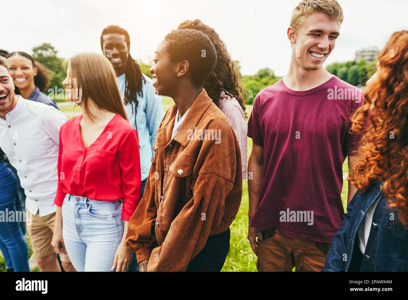 Multiracial young friends having fun outdoor - Focus on african girl face Stock Photo