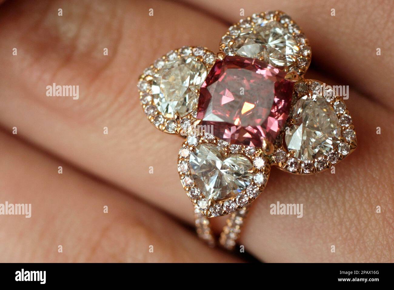 A Christie s employee displays a very rare purplish red diamond