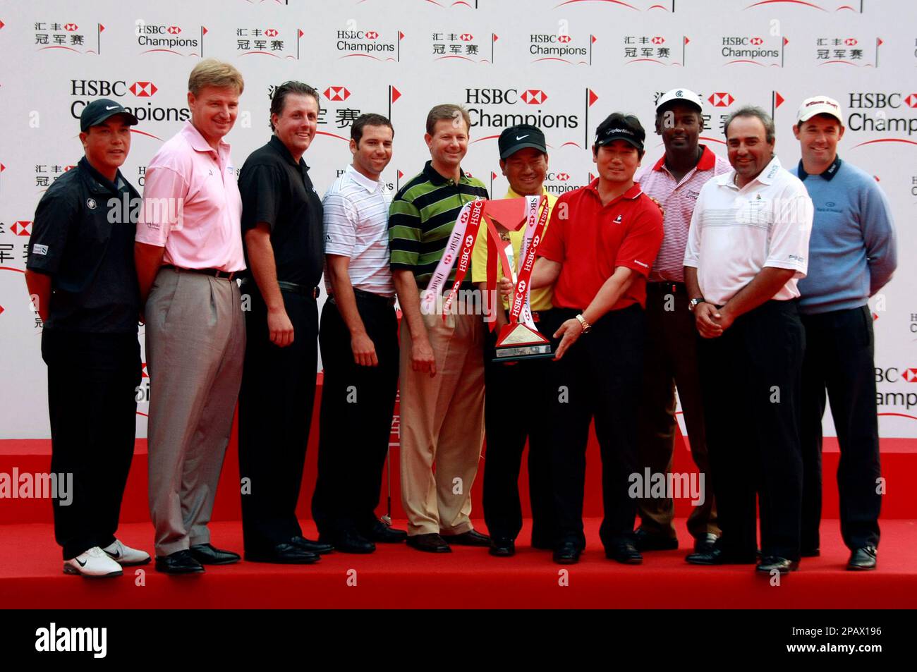 Vijay Singh of Fiji holds the championship trophy with Mickey