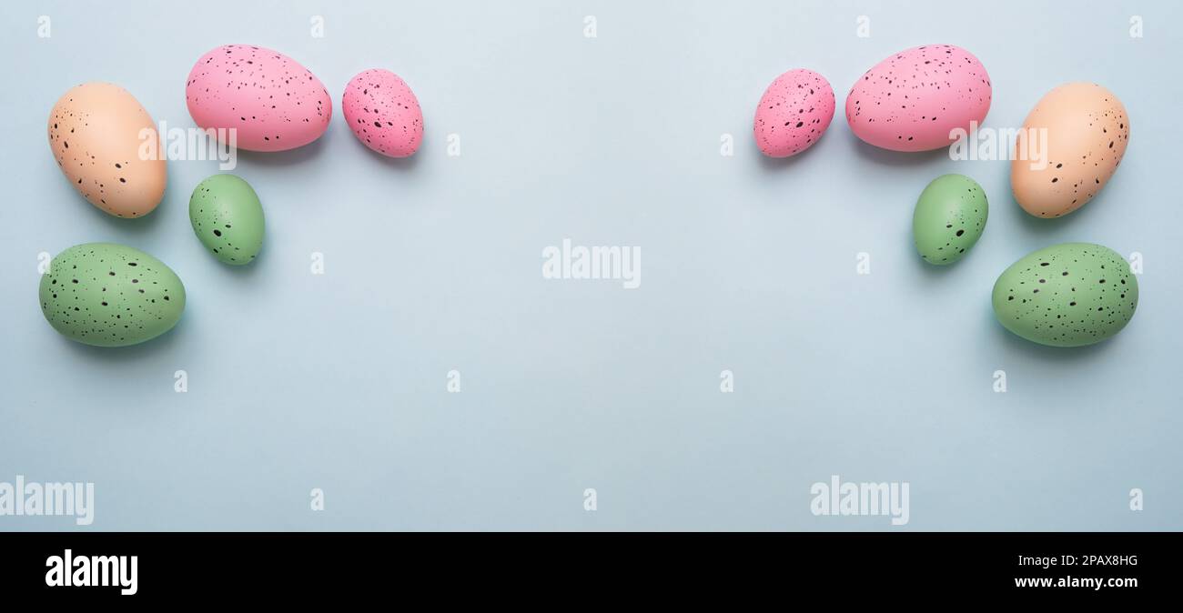 Frame from multicolored eggs on blue background.Easter concept. Stock Photo