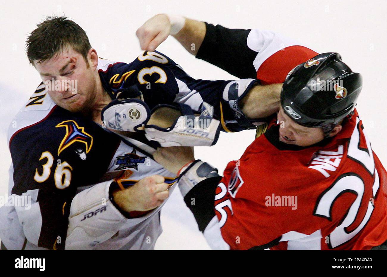 Ottawa Senators' Chris Neil, right, fights for control of the puck