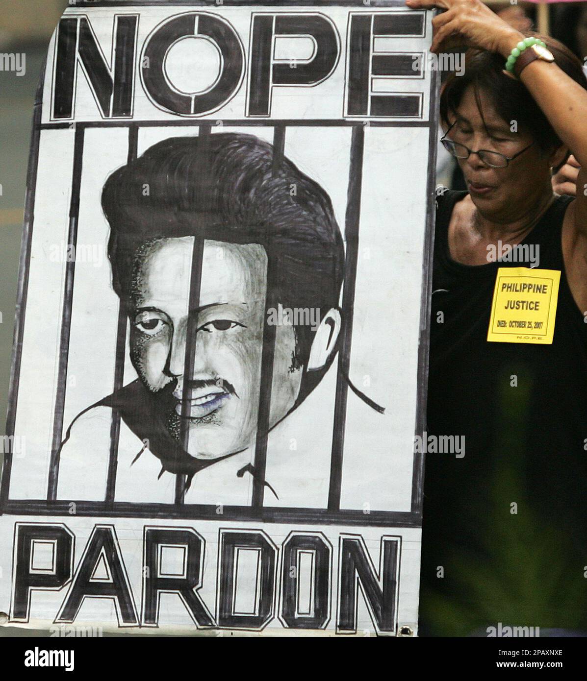 A protester holds up a poster of Philippine President Joseph