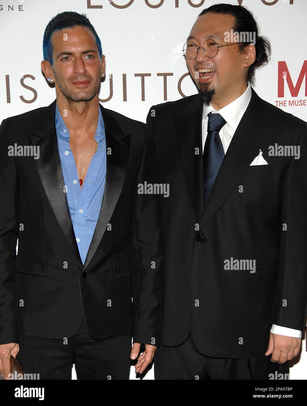 Fashion designer Marc Jacobs, left, and artist Takashi Murakami, right,  pose on the press line at the Murakami Exhibition Gala honoring Louis  Vuitton artistic director Marc Jacobs in Los Angeles on Sunday
