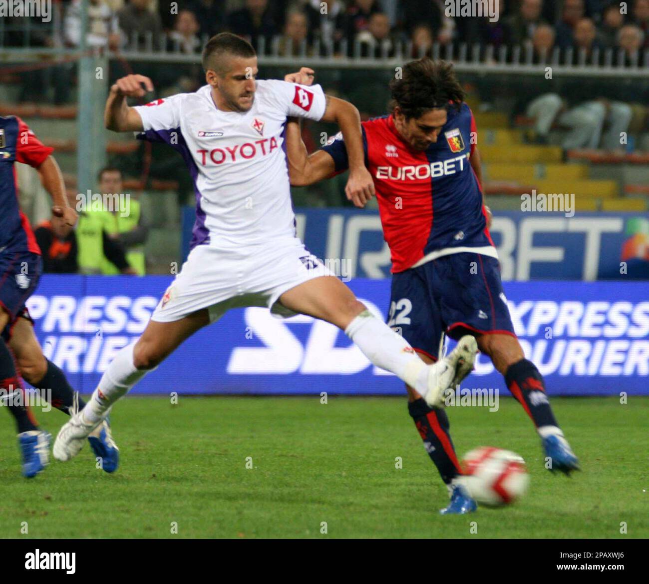 Fiorentina s defender Alessandro Gamberini left goes to tackle