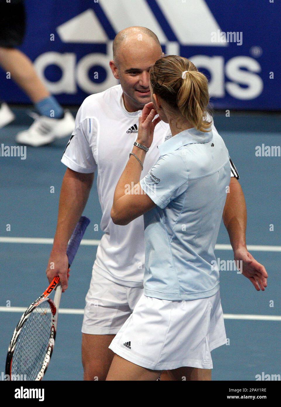 Steffi Graf and Andre Agassi talk to each other during the BASF Festival  for Children mixed doubles tennis match between Steffi Graf/Andre Agassi  and Justine Henin/Goran Ivanisevic at the SAP-Arena in Mannheim,