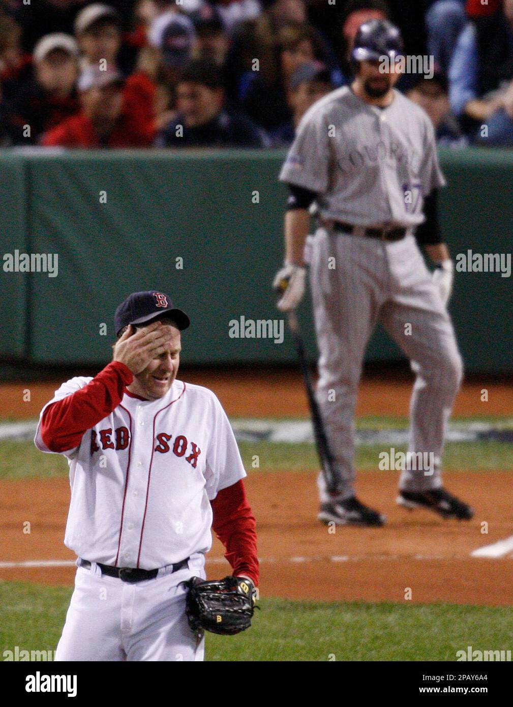 Boston Red Sox starter Curt Schilling wipes his head before pitching to  Colorado Rockies' Todd Helton during the first inning in Game 2 of the  baseball World Series Thursday, Oct. 25, 2007