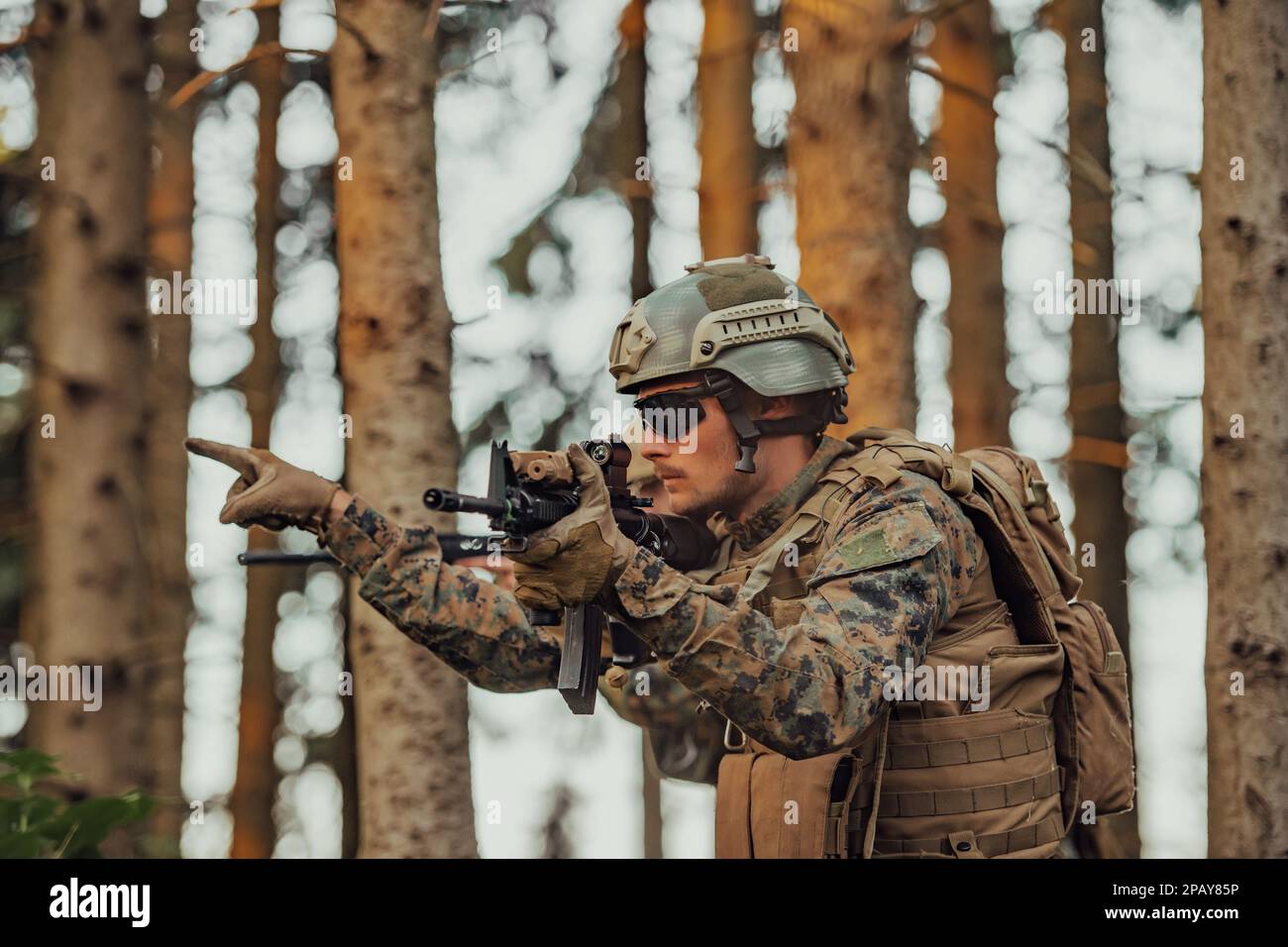 Modern warfare soldier officer is showing tactical hand signals to