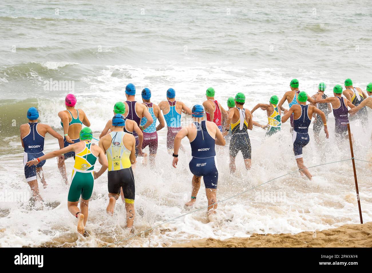 Running start of the swimming competition at the  National Schools Triathlon in Hervey Bay,Torquay, Queensland, Australia Stock Photo